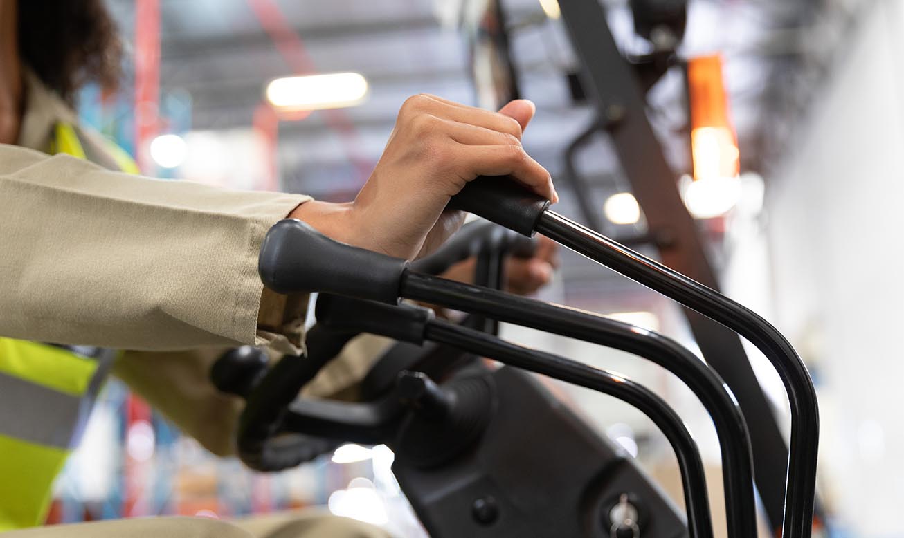 Woman handling a machine in factory