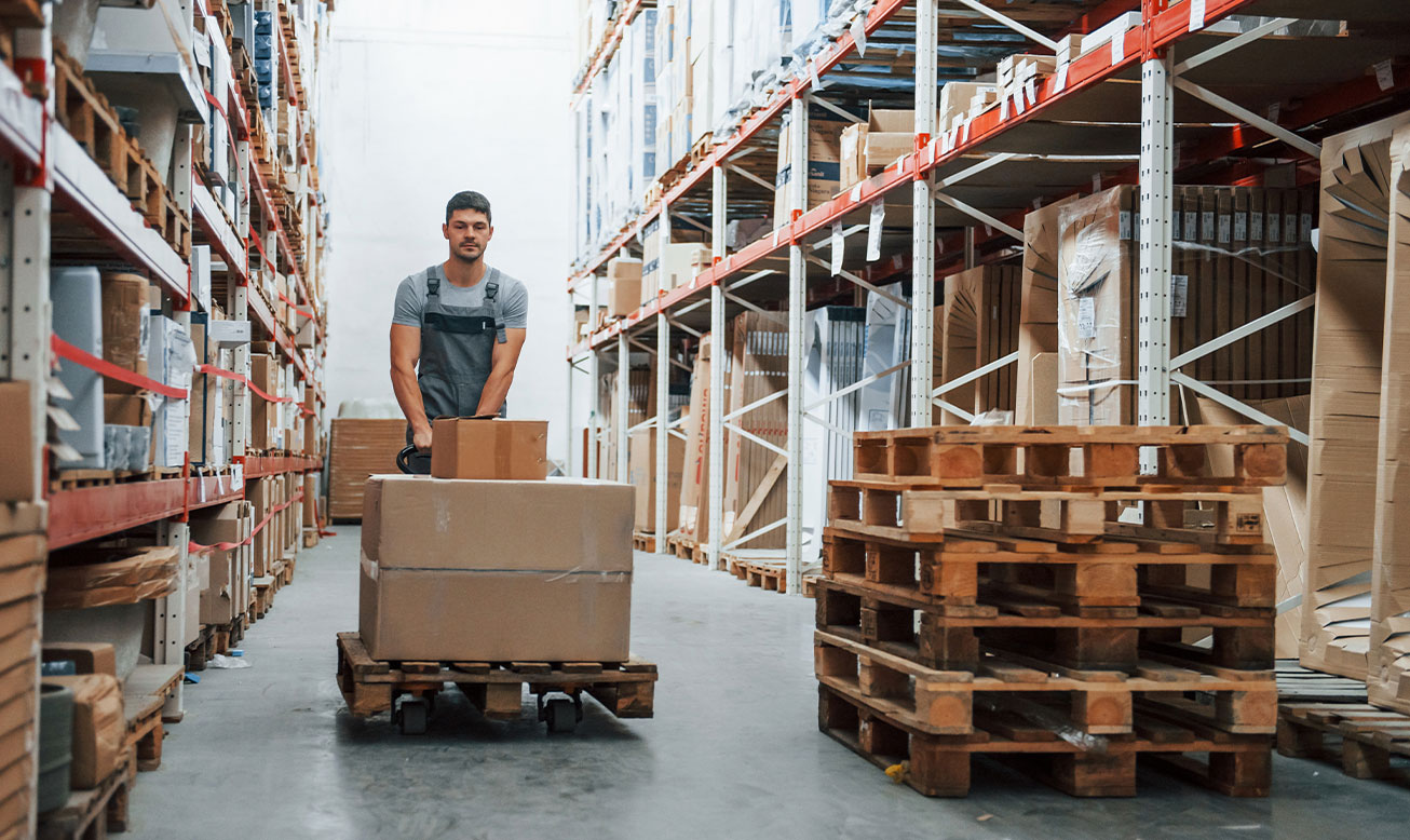 warehouse worker moving pallets of inventory